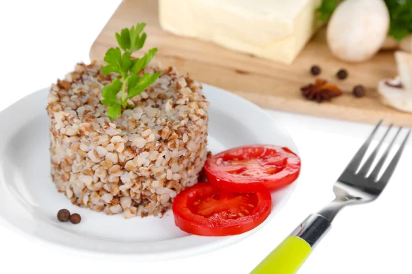 Sarrasin en assiette avec beurre et légumes isolés sur blanc — Photo