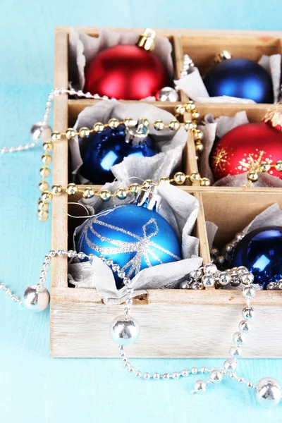 Christmas toys in box on wooden table close-up — Stock Photo, Image