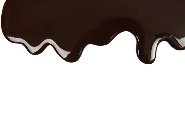 Melted chocolate dripping on white background — Stock Photo, Image