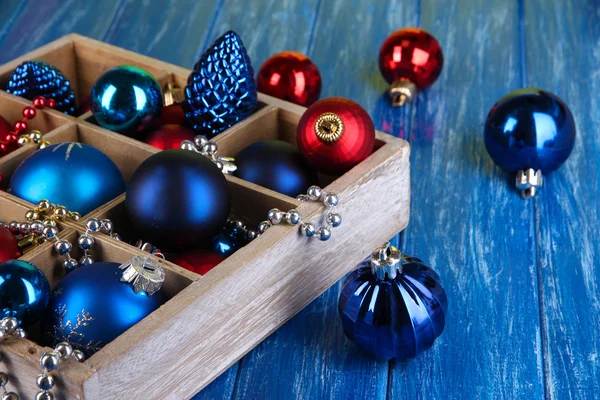 Christmas toys in box on wooden table close-up — Stock Photo, Image