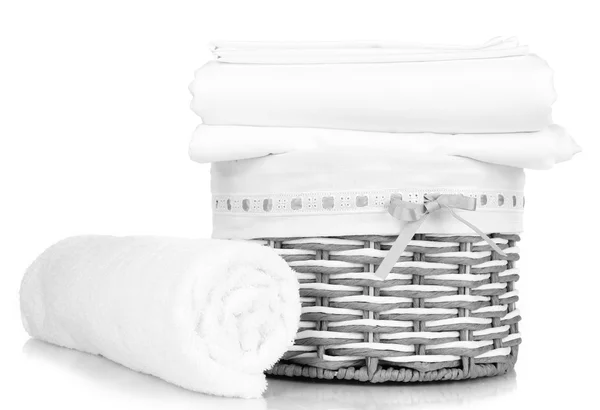 Bedding sheets in wicker basket isolated on white — Stock Photo, Image