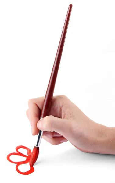 Hand holding brush with red paint — Stock Photo, Image