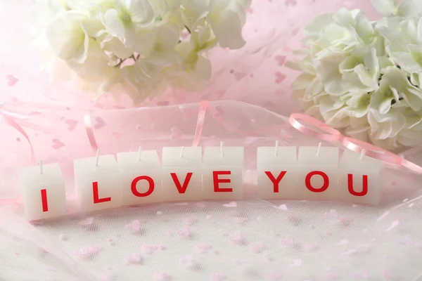 Candles with printed sign I LOVE YOU,on light background — Stock Photo, Image