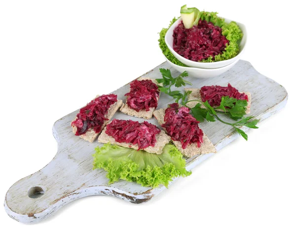 Beet salad on toasts and in plates on board isolated on white — Stock Photo, Image