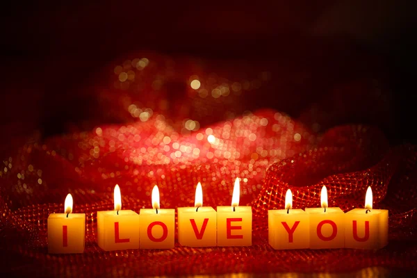 Candles with printed sign I LOVE YOU,on bright background — Stock Photo, Image