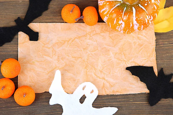 Old paper with Halloween decorations on grey wooden background — Stock Photo, Image