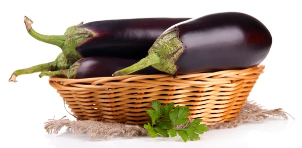 Verse aubergines in rieten mand geïsoleerd op wit — Stockfoto