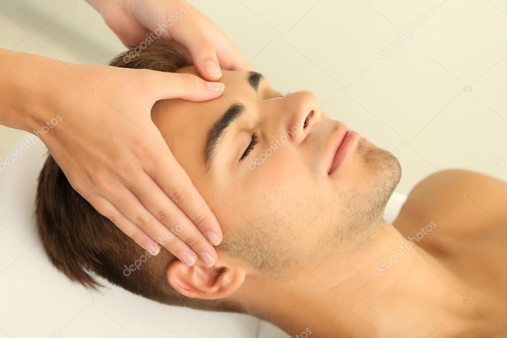 Download - Man having head massage close up - Stock Image