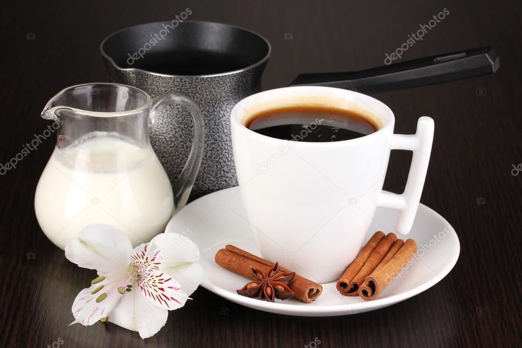 Cup of coffee with rahat delight and milk on wooden table