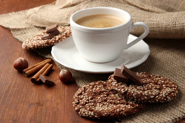 Cup of tasty coffee with tasty cookies, on wooden background — Stock Photo, Image