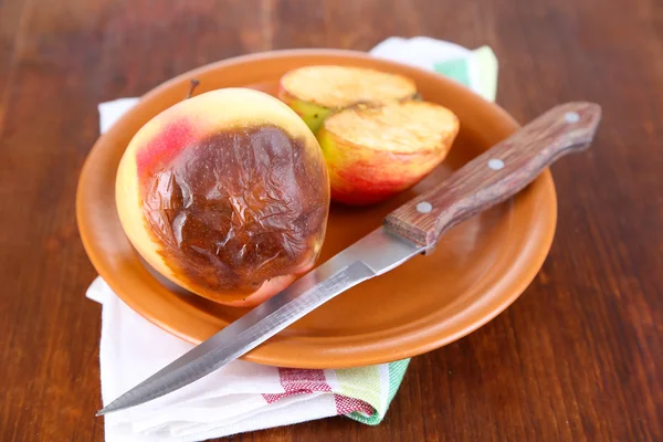 Gammelige Äpfel auf Teller auf Tisch — Stockfoto