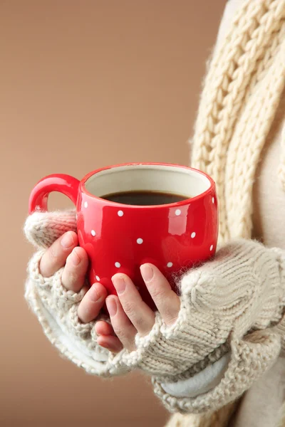 Female hands with hot drink, on color background — Stock Photo, Image