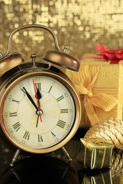 Composition of clock and christmas decorations on bright background — Stock Photo, Image