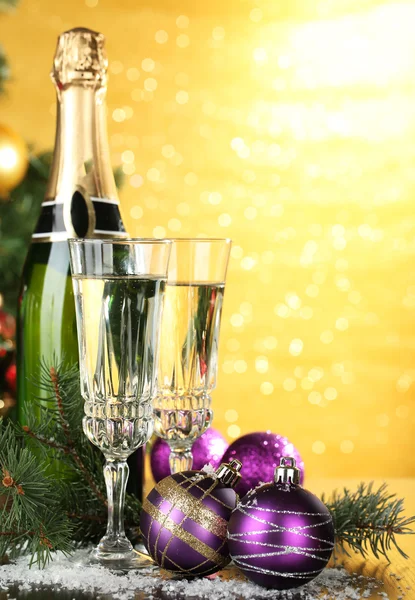 Composition with Christmas decorations and two champagne glasses, on bright background — Stock Photo, Image