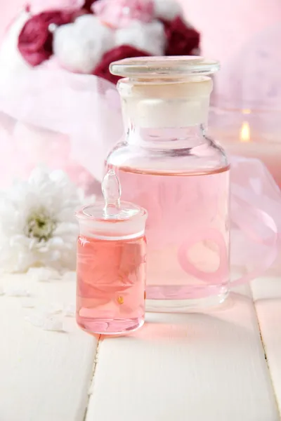 Glass bottle with color essence, on wooden background — Stock Photo, Image