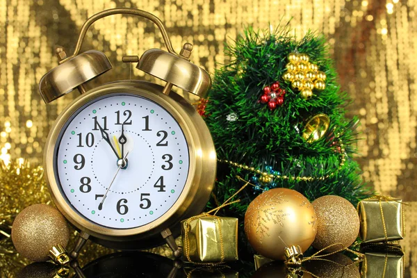 Composition of clock and christmas decorations on bright background — Stock Photo, Image