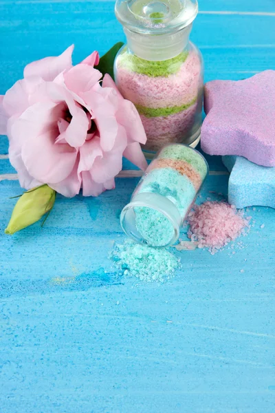 Aromatic salts in glass bottles, on blue background — Stock Photo, Image