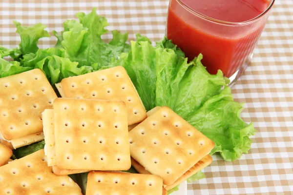 Sandwich crackers with cheese and tomato juice on tablecloth — Stock Photo, Image