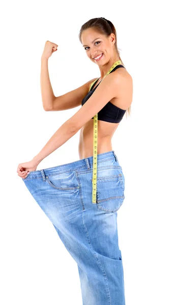 Slim girl in big jeans isolated on white — Stock Photo, Image