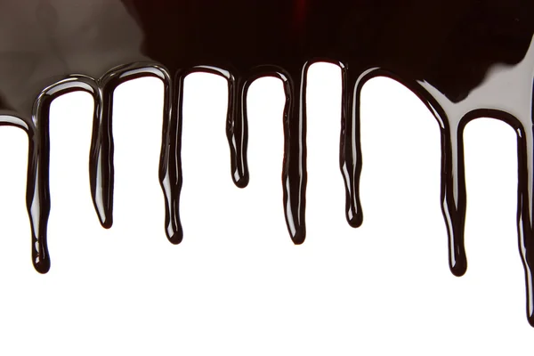 Melted chocolate dripping on white background — Stock Photo, Image