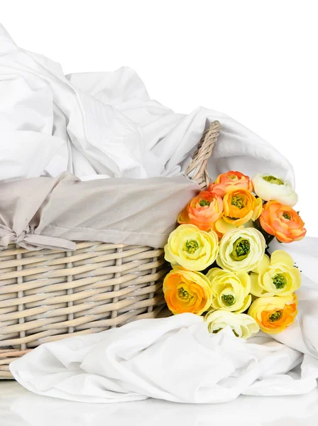 Rumpled bedding sheets in wicker basket isolated on white — Stock Photo, Image