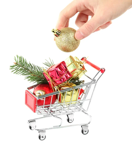 Hand and Christmas gifts in shopping trolley, isolated on white — Stock Photo, Image