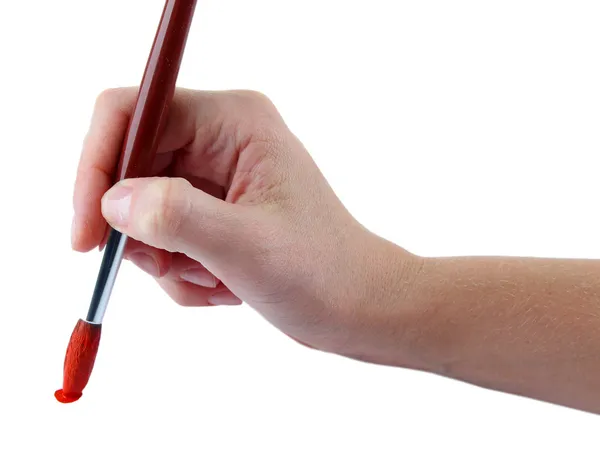 Hand holding brush with red paint isolated on white — Stock Photo, Image