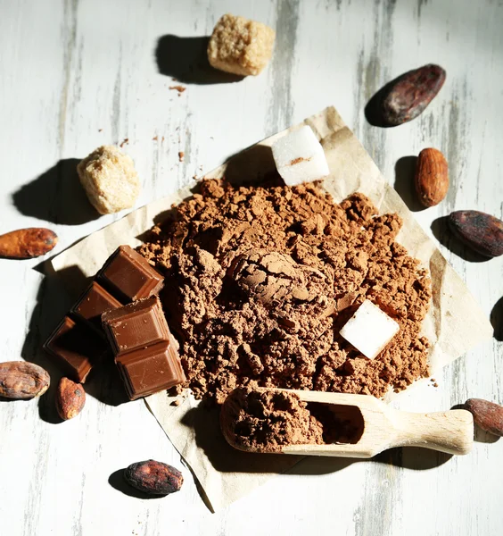 Cocoa powder on wooden table — Stock Photo, Image