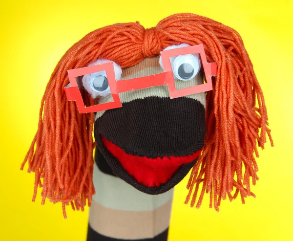 Cute sock puppet on yellow background — Stock Photo, Image