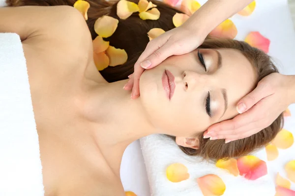 Beautiful young woman during facial massage in cosmetic salon close up — Stock Photo, Image