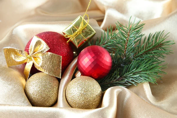 Beautiful Christmas decor on golden satin cloth — Stock Photo, Image