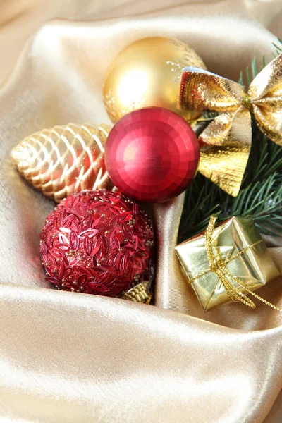 Beautiful Christmas decor on golden satin cloth — Stock Photo, Image