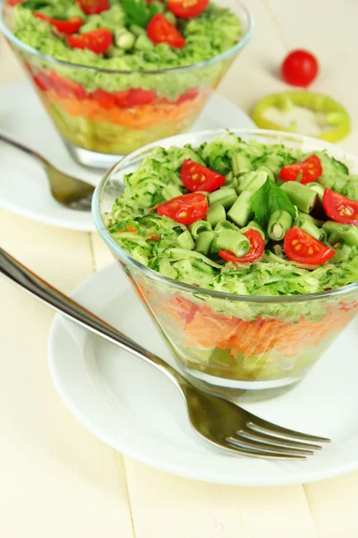 Tasty salad with fresh vegetables on wooden table Stock Image