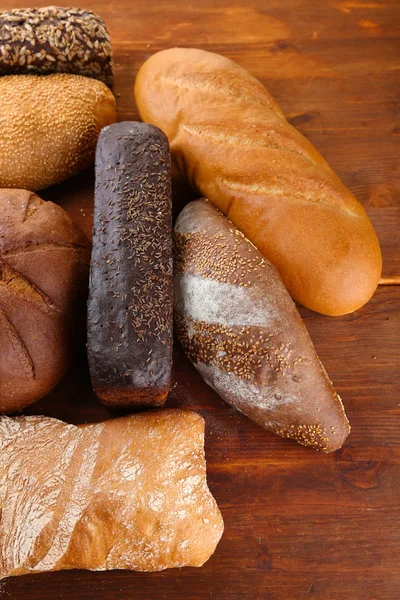 Much bread on wooden board — Stock Photo, Image