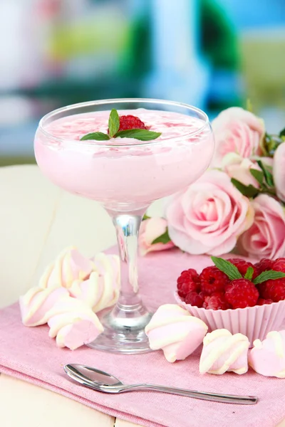 Raspberry milk dessert in cocktail glass, on bright background — Stock Photo, Image