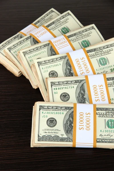 Stacks of money on wooden table — Stock Photo, Image