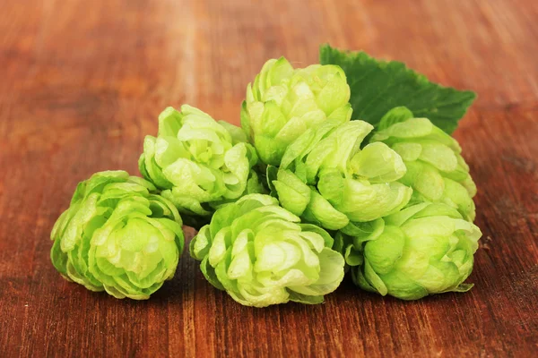 Fresh green hops, on wooden background — Stock Photo, Image