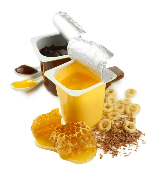 Tasty desserts in open plastic cups and honey combs, isolated on white — Stock Photo, Image