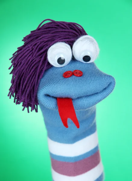 Cute sock puppet on green background — Stock Photo, Image