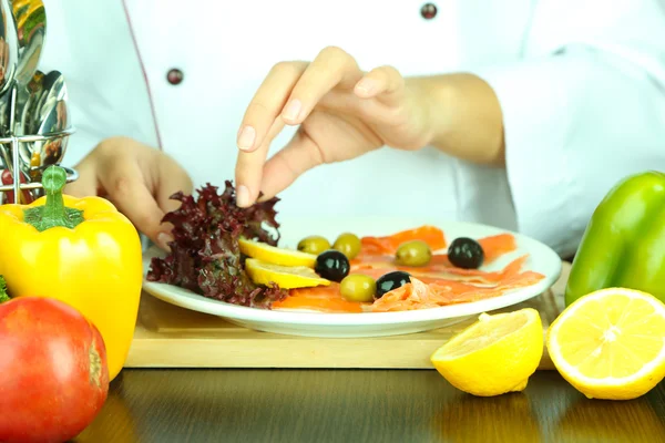 Cook hands decorating dish — Stock Photo, Image