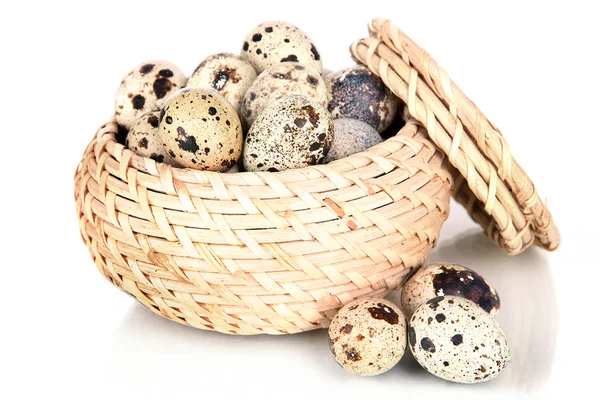 Quail eggs in wicker basket isolated on white — Stock Photo, Image