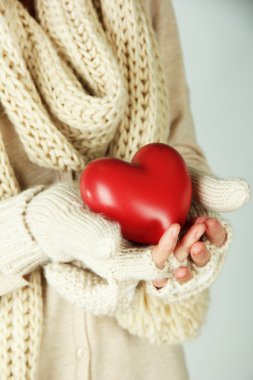 Female hands with red heart, close-up clipart