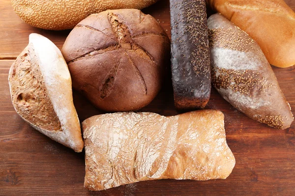 Much bread on wooden board — Stock Photo, Image