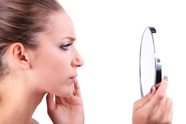 Beautiful girl preens before small mirror isolated on white — Stock Photo, Image