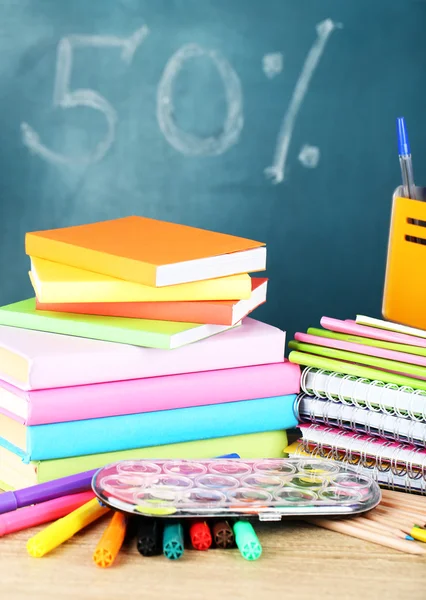 Office supplies on table on school board background — Stock Photo, Image