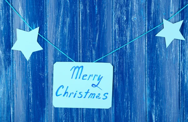 Signboard with words Merry Christmas on blue wooden table background close-up — Stock Photo, Image