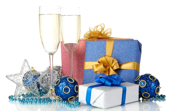 Glasses of champagne with gift boxes isolated on white — Stock Photo, Image