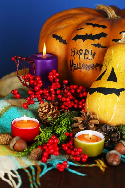 Composition for Halloween with pumpkins and candles on color background — Stock Photo, Image