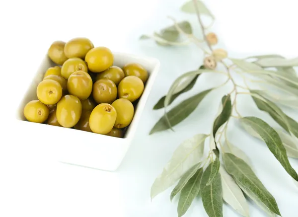 Olives in bowl with branch isolated on white — Stock Photo, Image