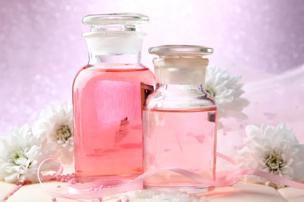 Glass bottles with color essence, on pink background — Stock Photo, Image